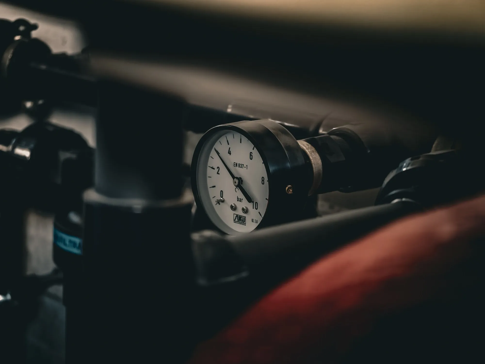 A pressure gauge connected to industrial piping.