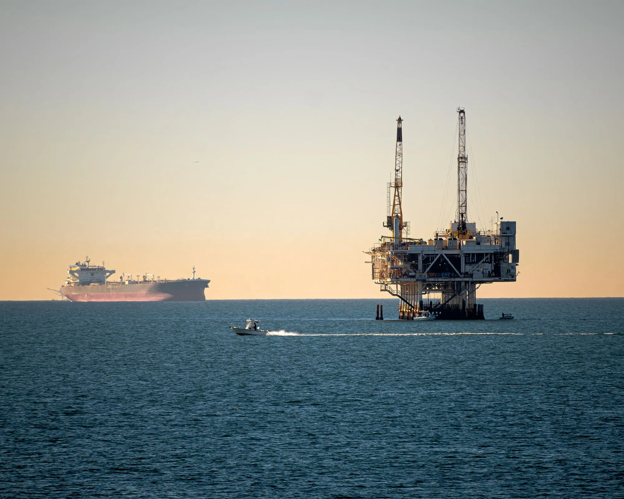 An offshore platform with vessels on the surrounding water.