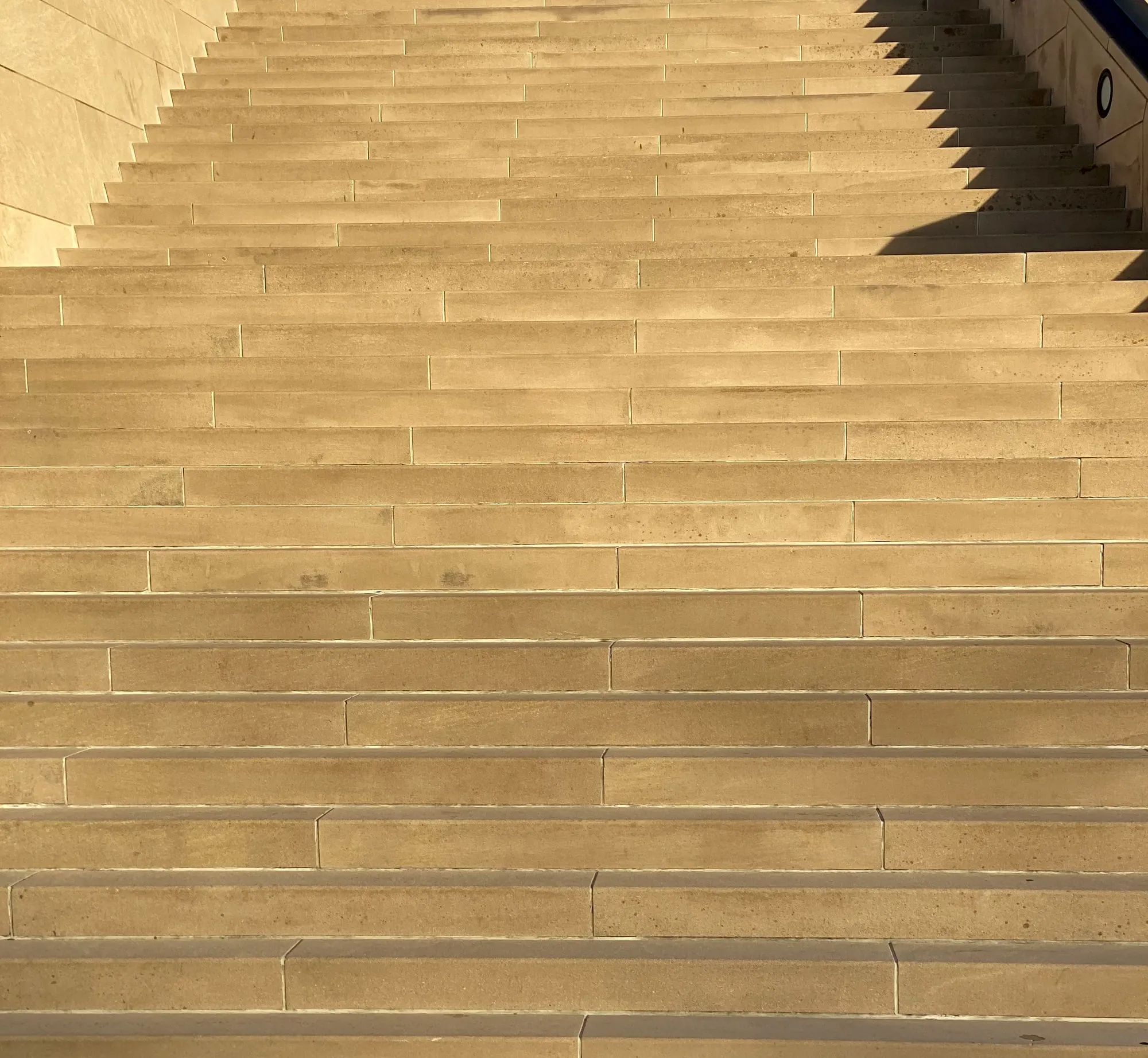 Sunlight on an empty flight of outdoor steps.